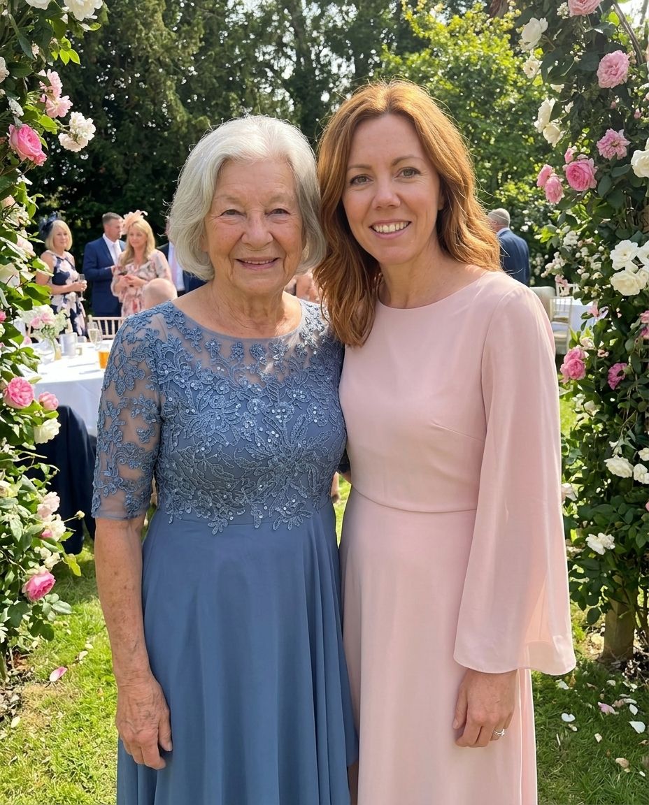 Two women smiling together at a garden party