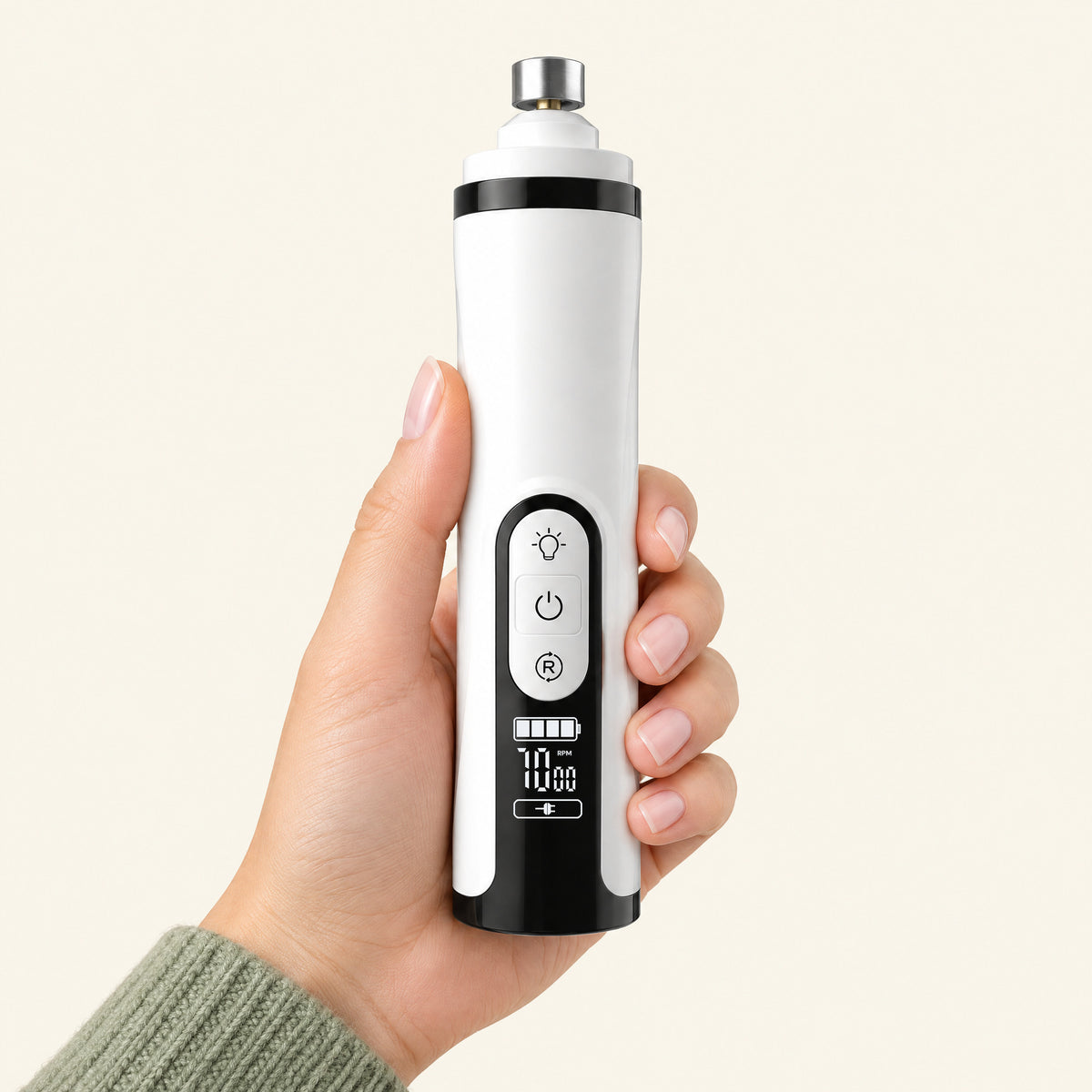 The nail grinder held in one hand, showing its size, the three front buttons and the display
